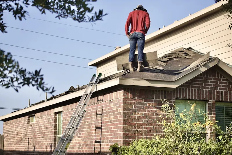 Professional roofer working on a residential roof in Baiting Hollow